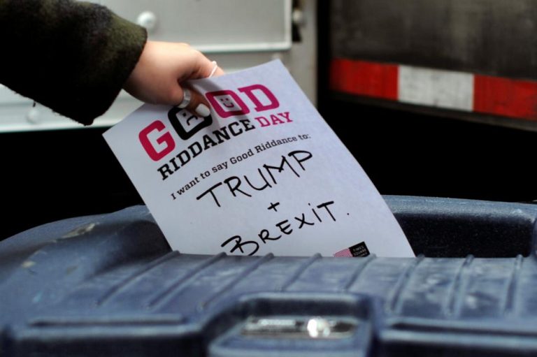A participant throws a piece of paper reading "Trump and Brexit" into a trash can to be shredded during "Good Riddance Day" in Times Square, New York City, December 28, 2016. Good Riddance Day is an annual event held in New York City for people to shred pieces of paper representing their bad memories or things they want to get rid of before the New Year. REUTERS/Darren Ornitz